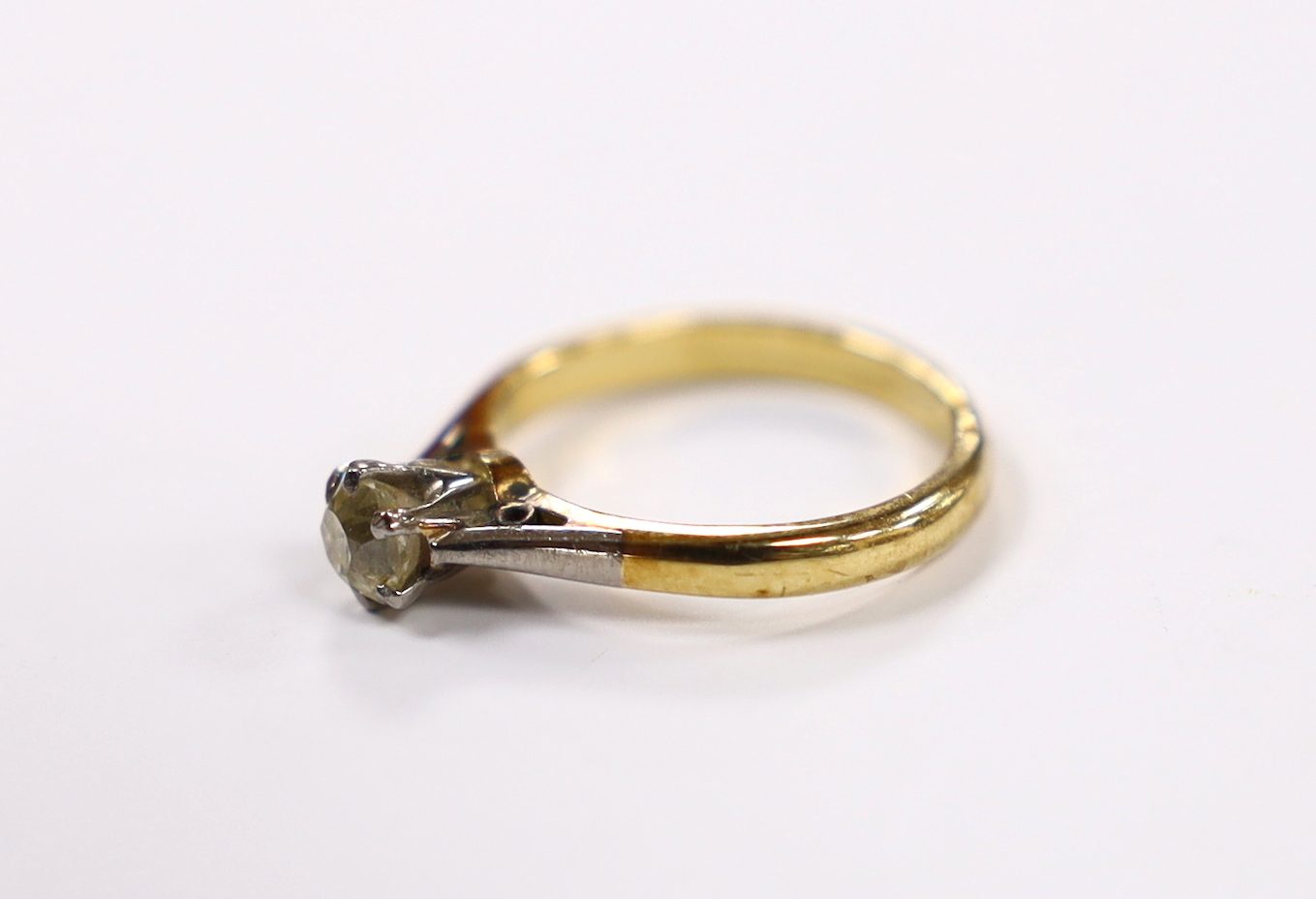 A yellow metal and solitaire diamond set ring, size G/H, gross weight 2.7 grams.